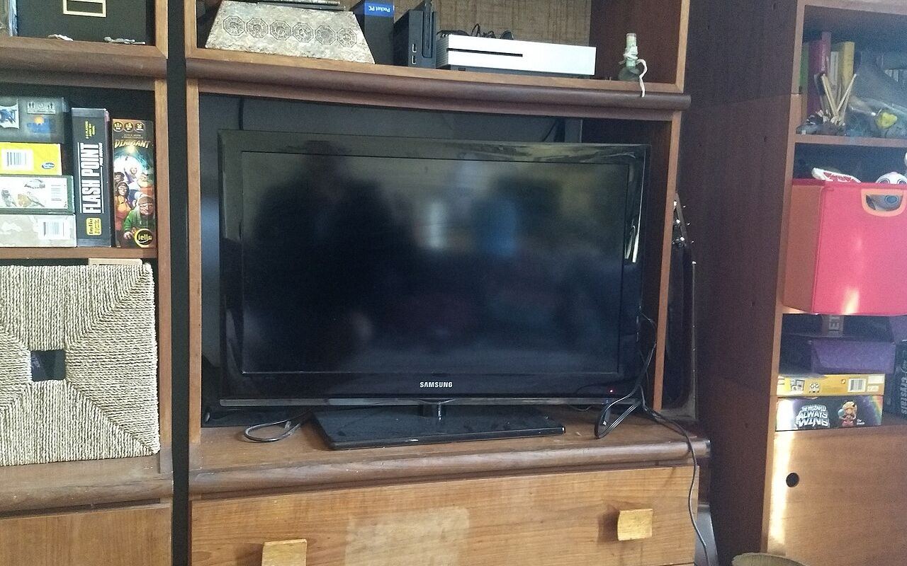 A flat-screen television in a bookshelf in the living room of a North American home