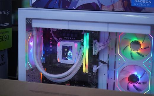 A ricer gaming PC with a white case, RGB fans and RAM sticks, and a CPU watercooler featuring a LCD display, at a store within Shenzhen Huaqiang…