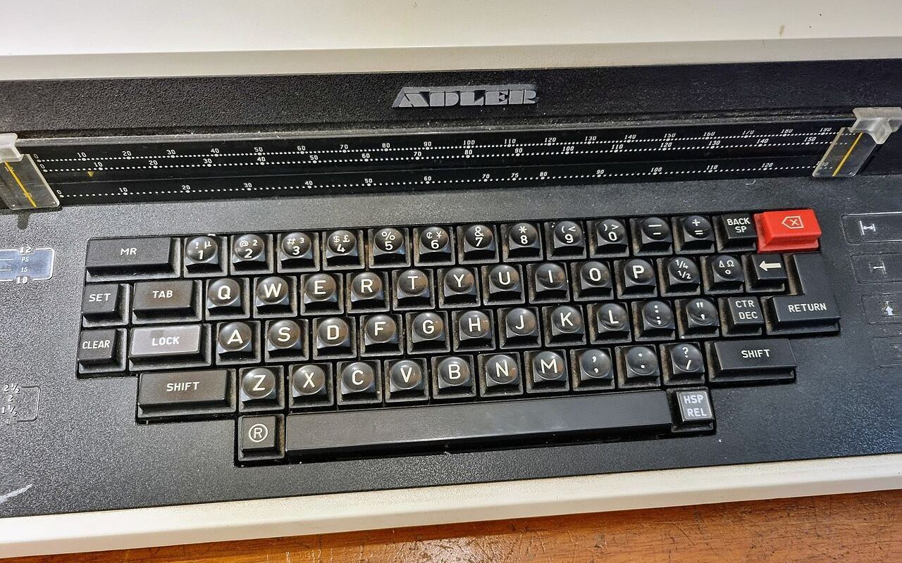 A close-up view of a vintage Adler typewriter keyboard